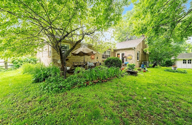 1027 Peggys Cv, Reynoldsburg, OH 43068 - view of grassy yard featuring central AC unit and french doors