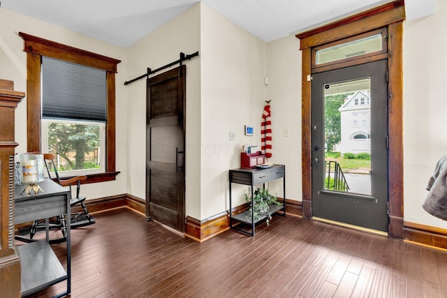 540 Linwood Ave, Columbus, OH 43205 - foyer with baseboards, a barn door, and dark wood finished floors