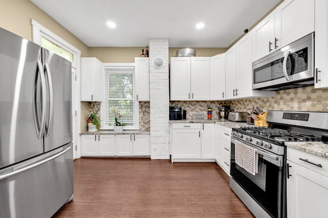 540 Linwood Ave, Columbus, OH 43205 - kitchen with stainless steel appliances, decorative backsplash, white cabinets, dark wood-type flooring, and recessed lighting