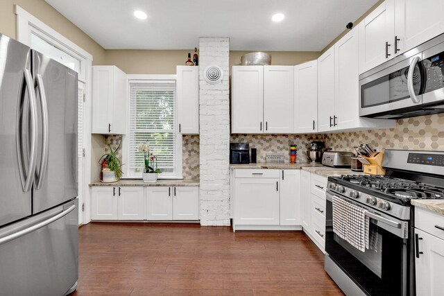 540 Linwood Ave, Columbus, OH 43205 - kitchen with appliances with stainless steel finishes, white cabinets, backsplash, light stone countertops, and recessed lighting