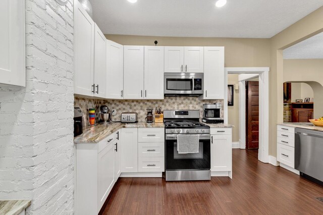540 Linwood Ave, Columbus, OH 43205 - kitchen with appliances with stainless steel finishes, dark wood-style flooring, and white cabinets