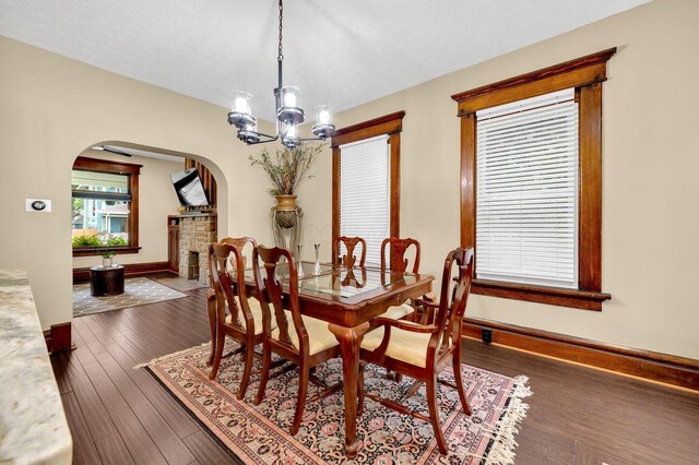 540 Linwood Ave, Columbus, OH 43205 - dining area featuring arched walkways, a chandelier, wood finished floors, and baseboards