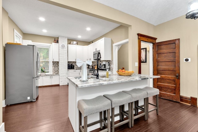 540 Linwood Ave, Columbus, OH 43205 - kitchen featuring stainless steel appliances, light stone counters, dark wood-type flooring, tasteful backsplash, and recessed lighting