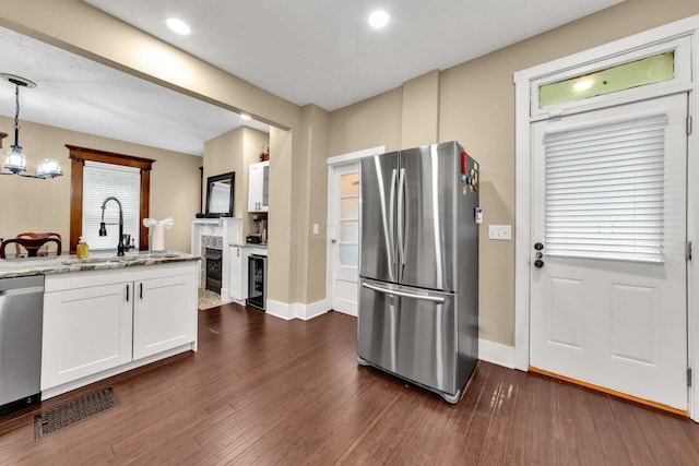 540 Linwood Ave, Columbus, OH 43205 - kitchen featuring appliances with stainless steel finishes, a sink, white cabinetry, dark wood-style floors, and baseboards