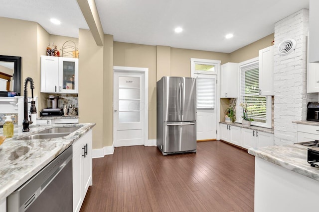 540 Linwood Ave, Columbus, OH 43205 - kitchen with stainless steel appliances, light stone counters, white cabinets, a sink, and backsplash