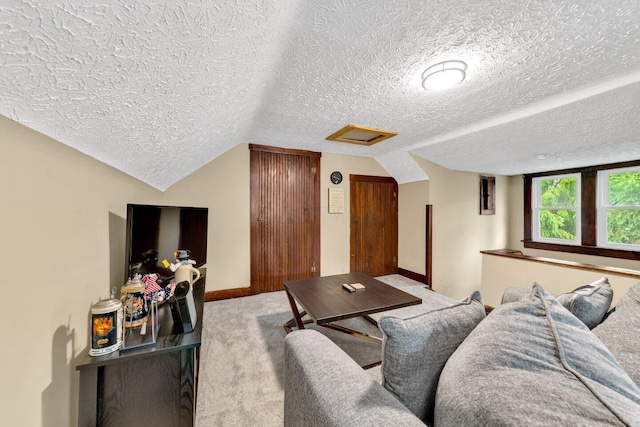 540 Linwood Ave, Columbus, OH 43205 - carpeted living room featuring attic access, a textured ceiling, vaulted ceiling, and baseboards