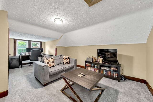 540 Linwood Ave, Columbus, OH 43205 - carpeted living room featuring a textured ceiling, baseboards, a desk, and vaulted ceiling