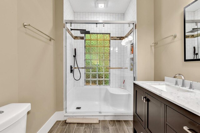 540 Linwood Ave, Columbus, OH 43205 - full bath with vanity, a tile shower, toilet, and wood finish floors