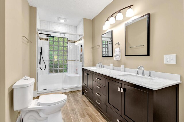 540 Linwood Ave, Columbus, OH 43205 - full bath with toilet, double vanity, a shower stall, and wood tiled floors