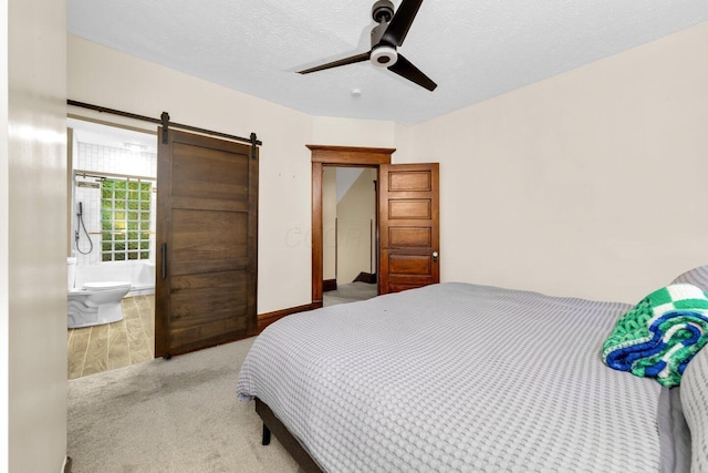 540 Linwood Ave, Columbus, OH 43205 - bedroom featuring carpet floors, a barn door, a textured ceiling, ensuite bath, and ceiling fan