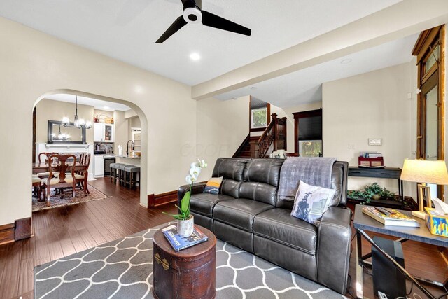 540 Linwood Ave, Columbus, OH 43205 - living room featuring arched walkways, ceiling fan, baseboards, hardwood / wood-style flooring, and stairway
