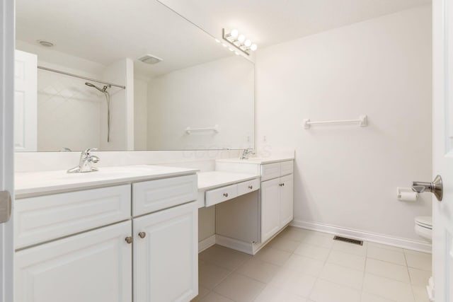 6618 Wild Rose Ln, Westerville, OH 43082 - bathroom featuring vanity, toilet, tile patterned floors, baseboards, and a shower
