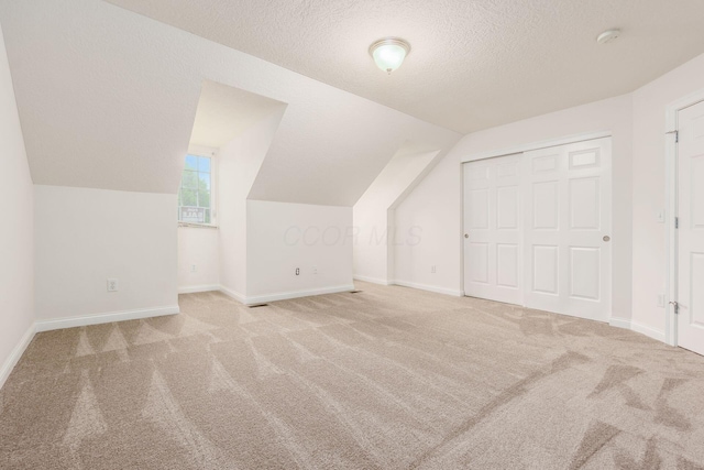 6618 Wild Rose Ln, Westerville, OH 43082 - bonus room featuring carpet flooring, vaulted ceiling, baseboards, and a textured ceiling