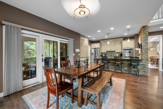6034 Heritage View Ct, Hilliard, OH 43026 - dining room with dark wood finished floors, ornate columns, and recessed lighting