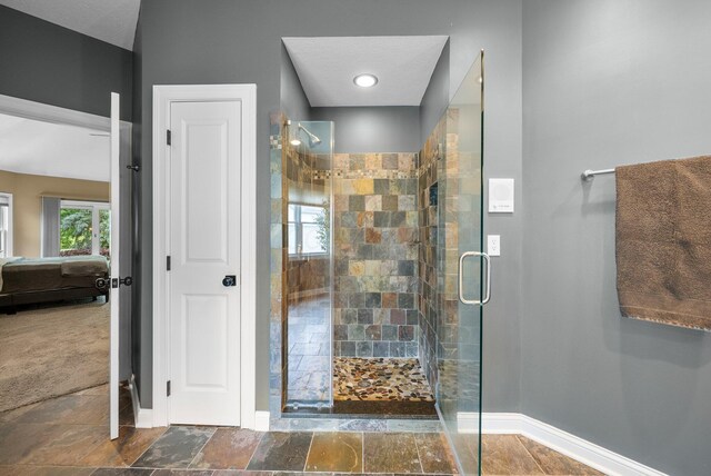 6034 Heritage View Ct, Hilliard, OH 43026 - bathroom featuring baseboards, a stall shower, and ensuite bath