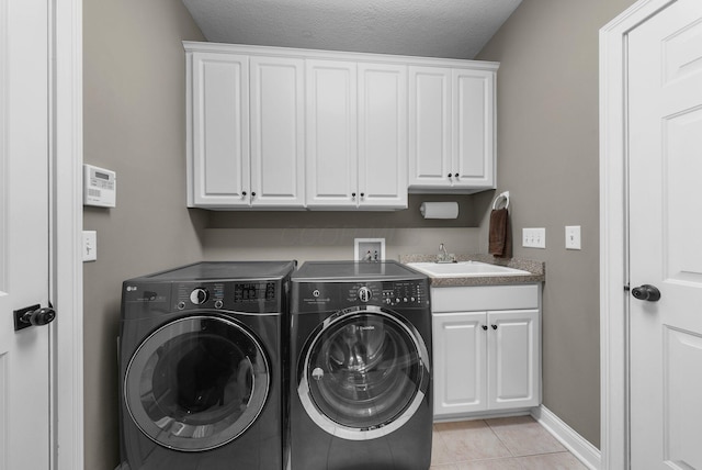 6034 Heritage View Ct, Hilliard, OH 43026 - washroom with cabinet space, washer and clothes dryer, baseboards, light tile patterned flooring, and a textured ceiling