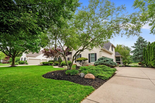 6034 Heritage View Ct, Hilliard, OH 43026 - obstructed view of property featuring a front lawn and stucco siding