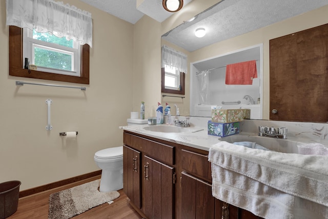 7682 Northridge Rd, Johnstown, OH 43031 - full bath featuring double vanity, toilet, plenty of natural light, wood finished floors, and a textured ceiling