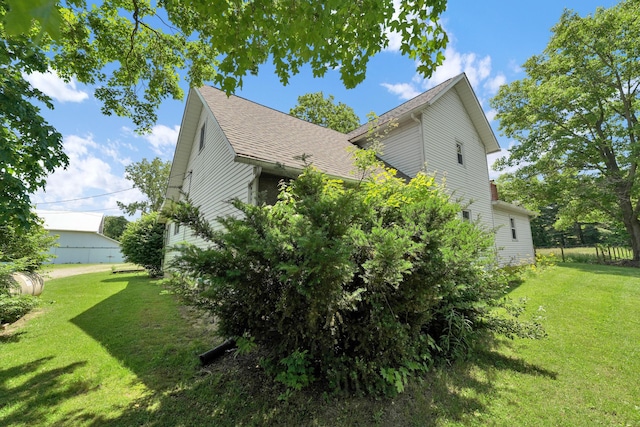 7682 Northridge Rd, Johnstown, OH 43031 - view of side of home with a yard and a shingled roof