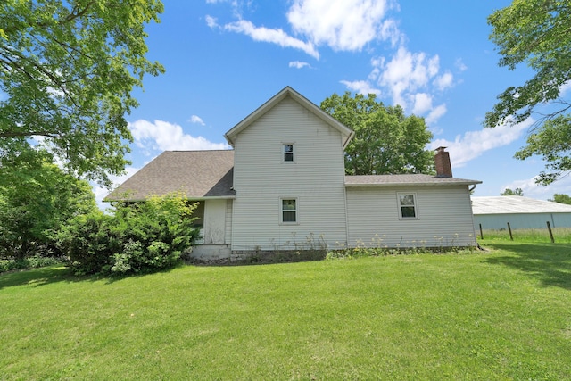 7682 Northridge Rd, Johnstown, OH 43031 - view of side of home featuring a chimney, a yard, and roof with shingles