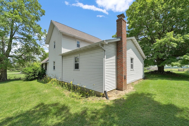 7682 Northridge Rd, Johnstown, OH 43031 - view of home's exterior featuring a lawn and a chimney
