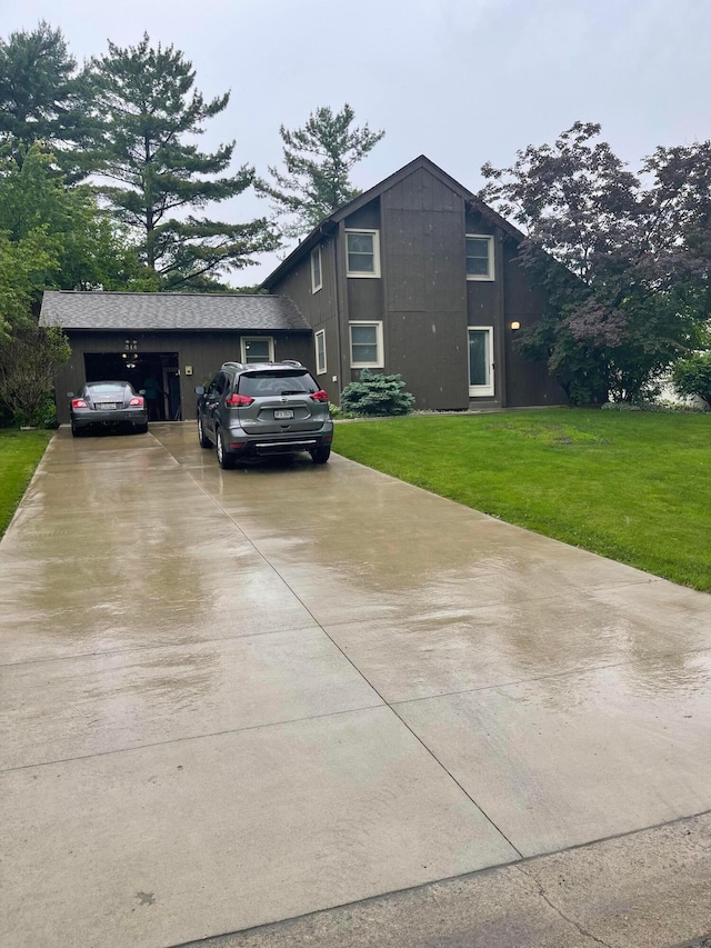 314 Broken Arrow Rd, Columbus, OH 43230 - view of side of property with driveway, a lawn, and an attached garage