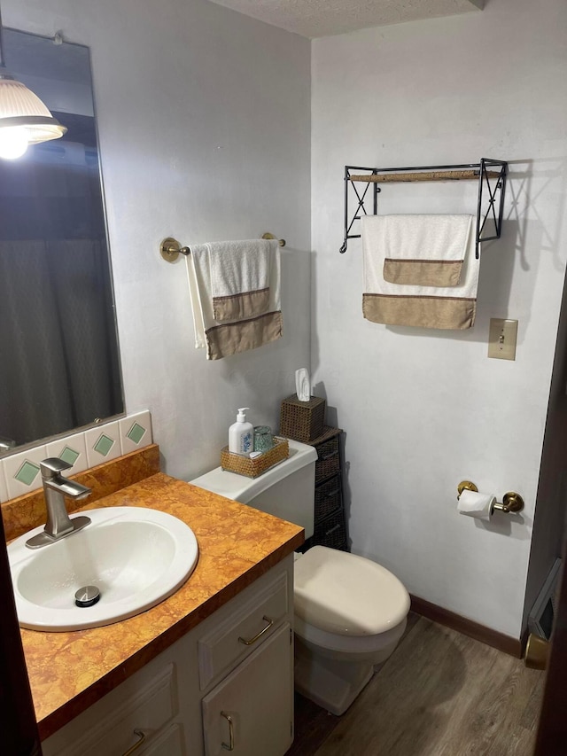 314 Broken Arrow Rd, Columbus, OH 43230 - bathroom featuring toilet, wood finished floors, vanity, and baseboards