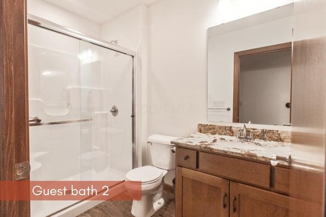 51 Appletree Ct, Howard, OH 43028 - bathroom featuring vanity, a stall shower, toilet, and wood finished floors