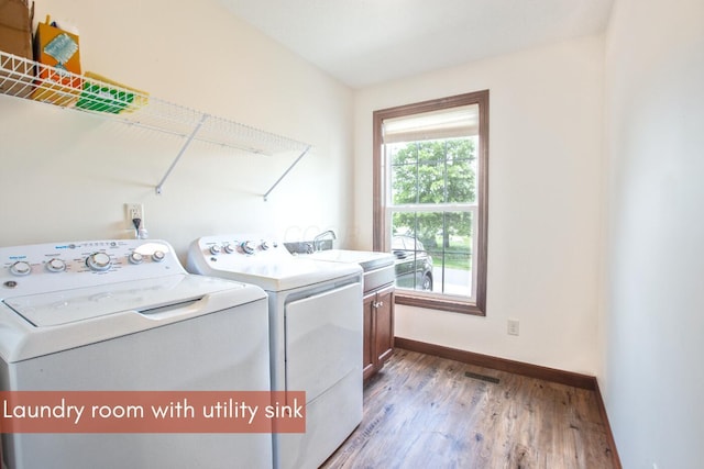 51 Appletree Ct, Howard, OH 43028 - laundry room with cabinet space, washing machine and dryer, baseboards, and wood finished floors