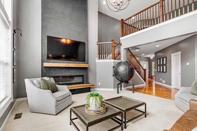 2505 Isabella Blue Dr, Powell, OH 43065 - carpeted living room with a towering ceiling, stairway, baseboards, recessed lighting, and a chandelier