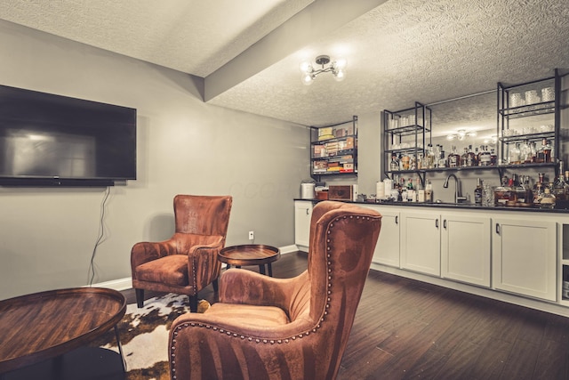 2505 Isabella Blue Dr, Powell, OH 43065 - indoor wet bar featuring dark wood-style flooring, a textured ceiling, and baseboards