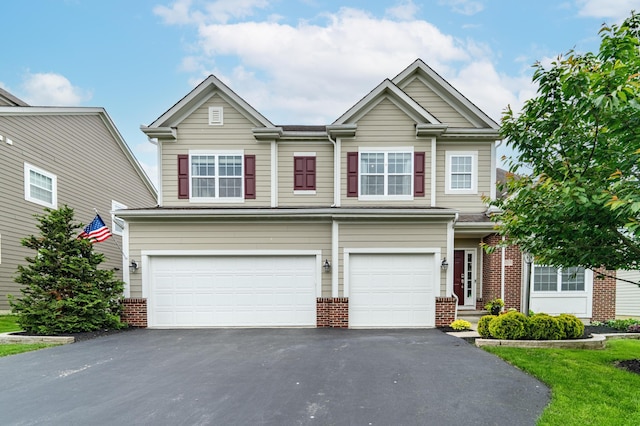 2505 Isabella Blue Dr, Powell, OH 43065 - view of front of property with a garage, driveway, and brick siding