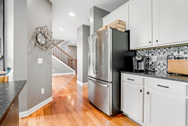 2505 Isabella Blue Dr, Powell, OH 43065 - kitchen with freestanding refrigerator, light wood-style floors, decorative backsplash, white cabinetry, and baseboards
