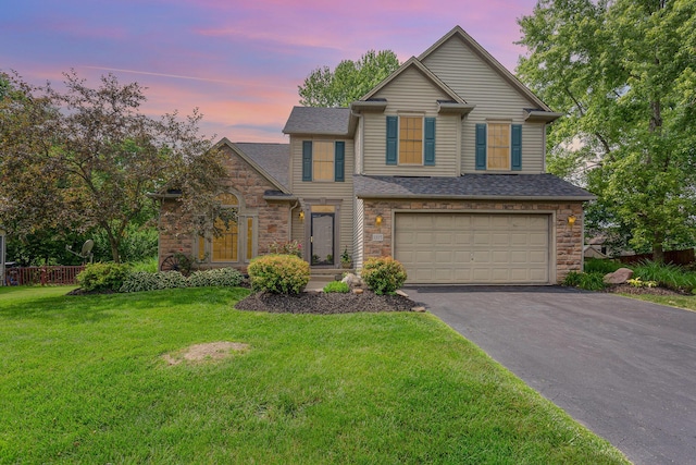 1315 Shelby Cir, Reynoldsburg, OH 43068 - traditional home featuring asphalt driveway, an attached garage, stone siding, and roof with shingles
