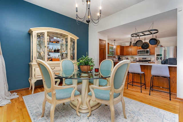 1315 Shelby Cir, Reynoldsburg, OH 43068 - dining area with a chandelier and light wood finished floors