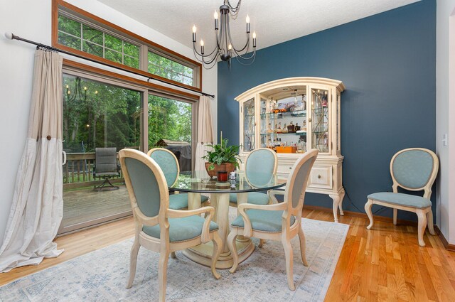 1315 Shelby Cir, Reynoldsburg, OH 43068 - dining room with a chandelier, wood finished floors, and a textured ceiling