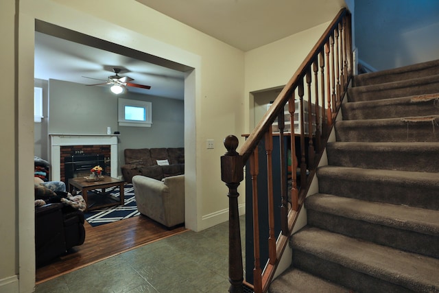 368 Alden Ave Unit 368, Columbus, OH 43201 - stairway with ceiling fan, a brick fireplace, and baseboards