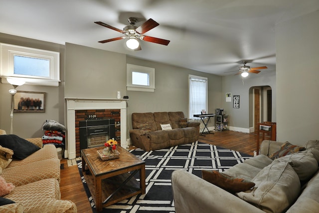 368 Alden Ave Unit 368, Columbus, OH 43201 - living room featuring ceiling fan, arched walkways, wood finished floors, a brick fireplace, and baseboards