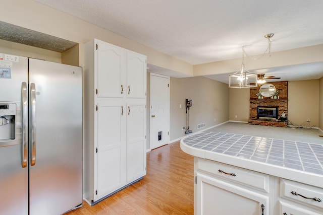 4071 Killary Dr, Dublin, OH 43016 - kitchen featuring stainless steel fridge with ice dispenser, tile countertops, white cabinetry, and open floor plan