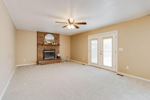 4071 Killary Dr, Dublin, OH 43016 - unfurnished living room featuring a ceiling fan, carpet, a fireplace, a textured ceiling, and french doors