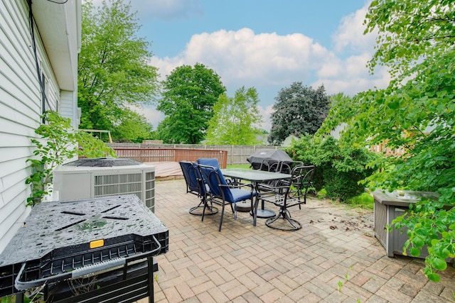 4071 Killary Dr, Dublin, OH 43016 - fenced backyard with outdoor dining area, cooling unit, a patio area, and area for grilling