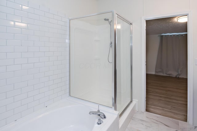 160 Cliff St, Buckeye Lake, OH 43008 - full bath with a shower with shower door, a bath, marble look tiles, and a textured ceiling