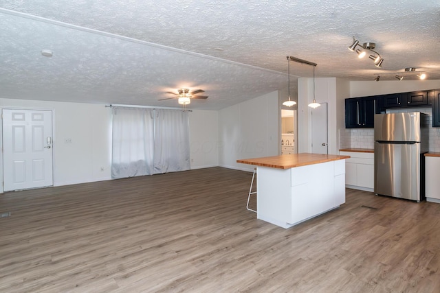 160 Cliff St, Buckeye Lake, OH 43008 - kitchen featuring freestanding refrigerator, butcher block countertops, open floor plan, light wood-style floors, and a textured ceiling