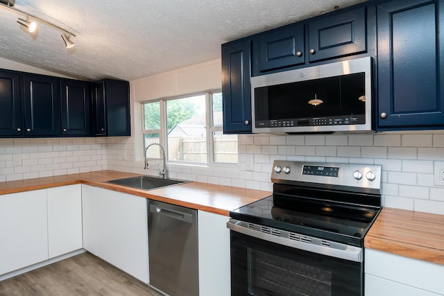 160 Cliff St, Buckeye Lake, OH 43008 - kitchen featuring stainless steel appliances, butcher block counters, a textured ceiling, blue cabinets, and light wood finished floors