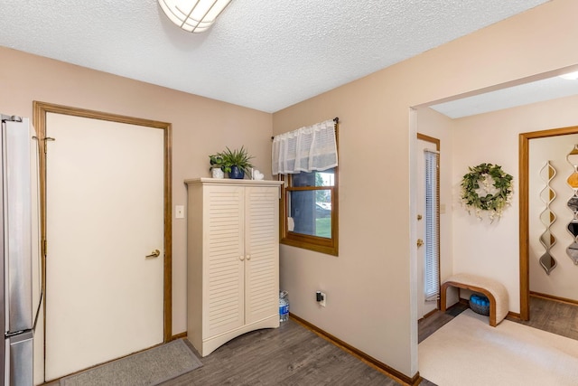 7179 Inverness Ct, Dublin, OH 43016 - laundry area featuring dark wood-style floors, baseboards, and a textured ceiling