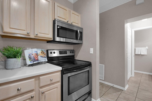 6221 Craughwell Ln, Dublin, OH 43017 - kitchen featuring stainless steel appliances, light brown cabinetry, light tile patterned floors, baseboards, and ornamental molding