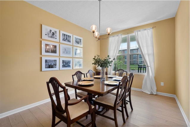 3834 Brody Dr, Grove City, OH 43123 - dining room with baseboards, light wood-type flooring, and a chandelier