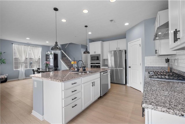 3834 Brody Dr, Grove City, OH 43123 - kitchen with a sink, appliances with stainless steel finishes, under cabinet range hood, light wood-type flooring, and recessed lighting