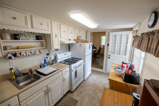 408 Olive St, Greenfield, OH 45123 - kitchen with white gas range oven, under cabinet range hood, a sink, and white cabinets