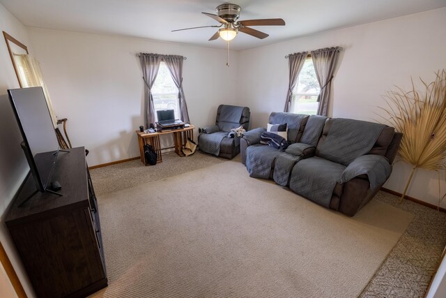 408 Olive St, Greenfield, OH 45123 - living area featuring healthy amount of natural light, light colored carpet, a ceiling fan, and baseboards